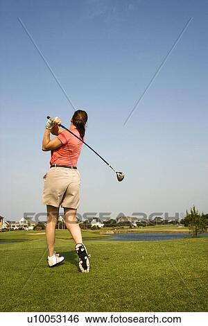 Back view of Caucasion mid-adult woman swinging golf club. View Large Photo Image Stock Photograph - Back view of Caucasion mid-adult woman swinging golf club.. Fotosearch