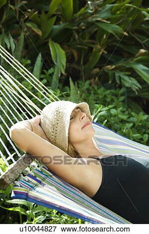 Caucasian mid-adult woman napping in hammock. View Large Photo Image Stock Photo - Caucasian mid-adult woman napping in hammock.. Fotosearch