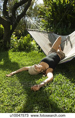 Caucasian mid-adult woman playing on hammock. View Large Photo Image Stock Image - Caucasian mid-adult woman playing on hammock.. Fotosearch