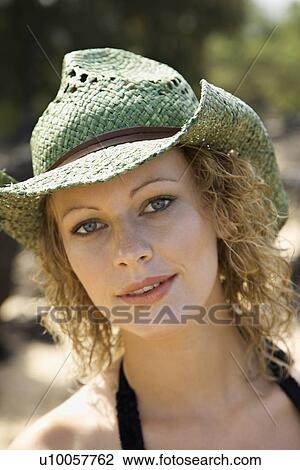 Stock Image - Close up portrait of young adult female Caucasian in hat.. Fotosearch