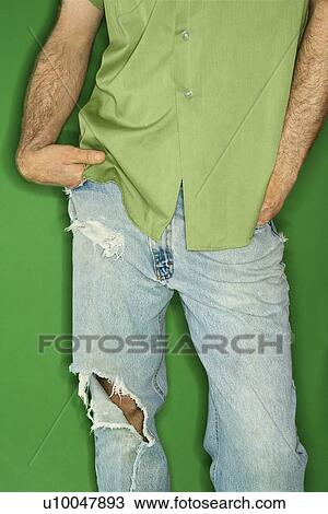 Mid body portrait of Caucasian man in torn blue jeans with hands in pockets. View Large Photo Image Stock Image - Mid body portrait of Caucasian man in torn blue jeans with hands in pockets.. Fotosearch