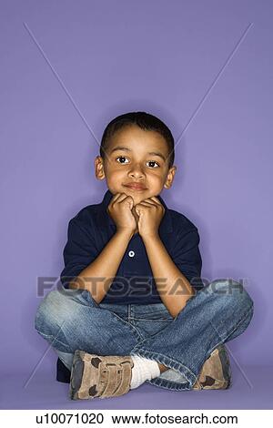 Stock Image - African American male child sitting portrait.. Fotosearch