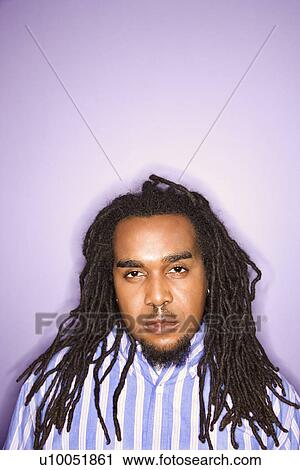 Serious African American Mid Adult Man On Purple Background Stock