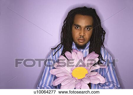 Serious African American Mid Adult Man Holding Big Fake Flower On