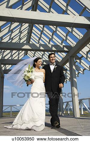 Caucasian mid-adult bride and groom walking together. View Large Photo Image Stock Image - Caucasian mid-adult bride and groom walking together.. Fotosearch