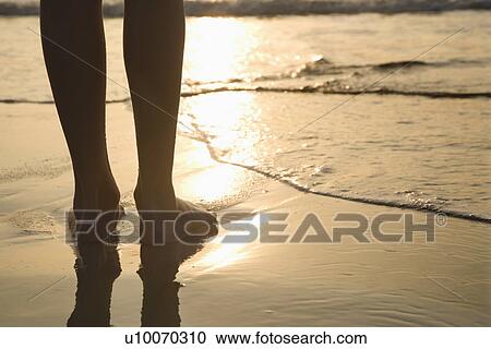 Caucasian person standing barefoot on beach in water. View Large Photo Image Stock Image - Caucasian person standing barefoot on beach in water.. Fotosearch