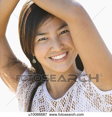 Portrait of young Asian female looking at viewer. View Large Photo Image Stock Photo - Portrait of young Asian female looking at viewer.. Fotosearch