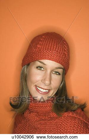 Head and shoulder portrait of smiling young adult Caucasian woman on orange background wearing winter hat and scarf. View Large Photo Image Stock Photograph - Head and shoulder portrait of smiling young adult Caucasian woman on orange background wearing winter hat and scarf.. Fotosearch