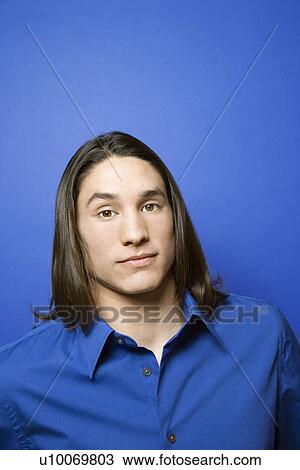 Portrait of Asian-American teen boy against blue background. View Large Photo Image Stock Image - Portrait of Asian-American teen boy against blue background. . Fotosearch