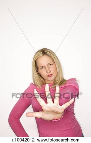 Portrait of blond Caucasian teen girl holding her hand out towards the viewer with attitude against white background. View Large Photo Image Stock Image - Portrait of blond Caucasian teen girl holding her hand out towards the viewer with attitude against white background.. Fotosearch