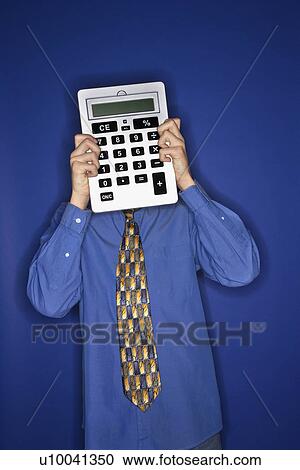 Portrait of Caucasian teen boy holding big calculator in front of face. View Large Photo Image Stock Image - Portrait of Caucasian teen boy holding big calculator in front of face.. Fotosearch