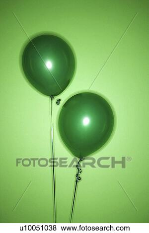 Stock Photo - Still life of green balloons on green background.. Fotosearch