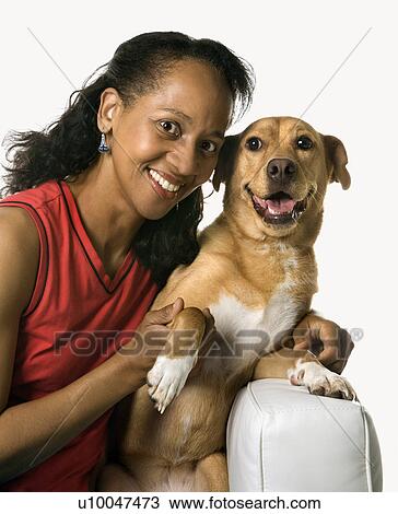 Stock Image - African American prime adult female with dog.. Fotosearch