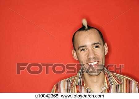 Caucasian man with mohawk smiling against red background. View Large Photo Image Stock Photography - Caucasian man with mohawk smiling against red background.. Fotosearch