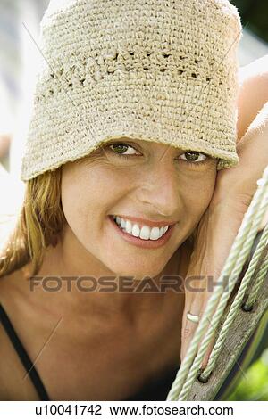 Stock Image - Caucasian mid-adult woman in hammock.. Fotosearch