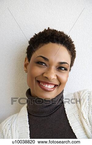 Close up head and shoulder of African- American woman standing against white wall smiling looking at viewer. View Large Photo Image Stock Image - Close up head and shoulder of African- American woman standing against white wall smiling looking at viewer.. Fotosearch