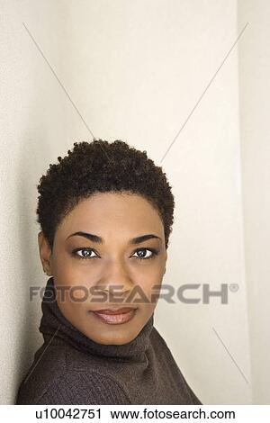 Stock Image - Close up of African-American woman looking at viewer.. Fotosearch