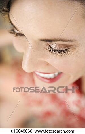 Stock Photograph - Close-up of mid-adult Caucasian woman smiling.. Fotosearch