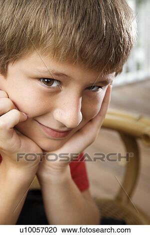 Portrait of Caucasian pre-teen boy with chin in hands looking at viewer and smiling. View Large Photo Image Stock Image - Portrait of Caucasian pre-teen boy with chin in hands looking at viewer and smiling.. Fotosearch