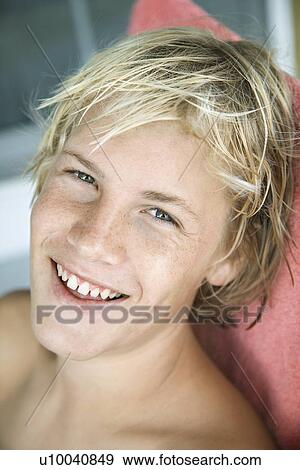 Stock Photo - Portrait of Caucasian teenage blond boy smiling.. Fotosearch