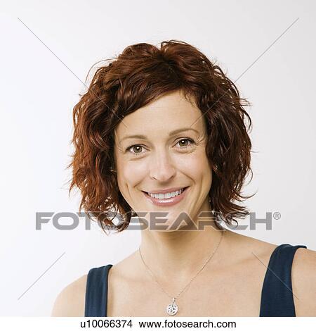Picture - Portrait of Caucasion mid-adult attractive woman looking at viewer and smiling.. Fotosearch