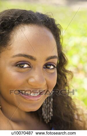 Young-adult Black woman making eye contact. View Large Photo Image Stock Photo - Young-adult Black woman making eye contact.. Fotosearch