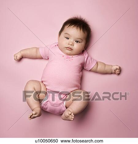 Asian baby lying on back lookin up at viewer with arms out to side. View Large Photo Image Stock Image - Asian baby lying on back lookin up at viewer with arms out to side.. Fotosearch
