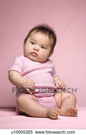 Stock Photography - Asian baby sitting up and looking to side.. Fotosearch