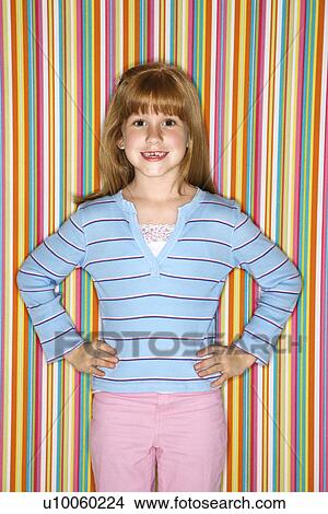 Caucasian female child looking at viewer with hands on hips. View Large Photo Image Picture - Caucasian female child looking at viewer with hands on hips.. Fotosearch
