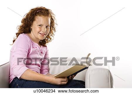 Picture - Caucasian female child sitting reading book.. Fotosearch