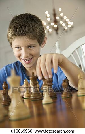 Caucasian pre-teen boy playing chess. View Large Photo Image Stock Image - Caucasian pre-teen boy playing chess.. Fotosearch