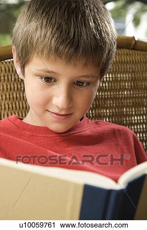 Caucasian pre-teen boy reading book. View Large Photo Image Stock Image - Caucasian pre-teen boy reading book.. Fotosearch