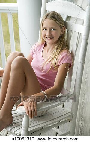 Caucasian pre-teen girl sitting in rocking chair on porch smiling. View Large Photo Image Stock Image - Caucasian pre-teen girl sitting in rocking chair on porch smiling.. Fotosearch
