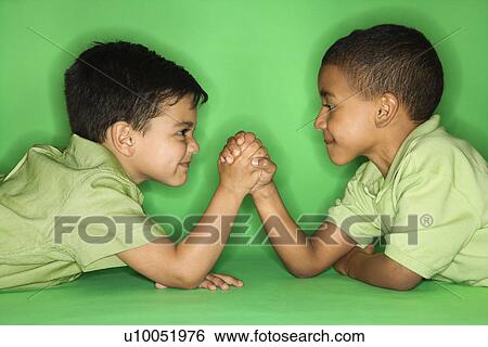 Hispanic and African American male child arm wrestling. View Large Photo Image Stock Photograph - Hispanic and African American male child arm wrestling.. Fotosearch