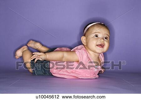 Hispanic female baby lying on stomach. View Large Photo Image Stock Image - Hispanic female baby lying on stomach.. Fotosearch