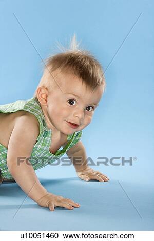 Stock Image - Portrait of Caucasian male child crawling.. Fotosearch