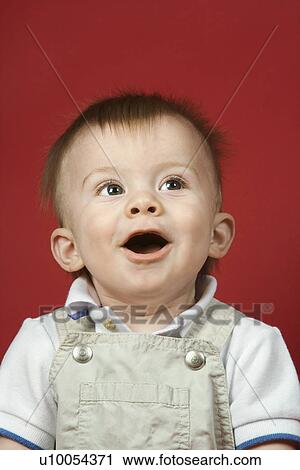 Stock Image - Portrait of Caucasian male child looking surprised.. Fotosearch
