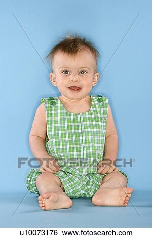 Stock Photograph - Portrait of Caucasian male child sitting.. Fotosearch