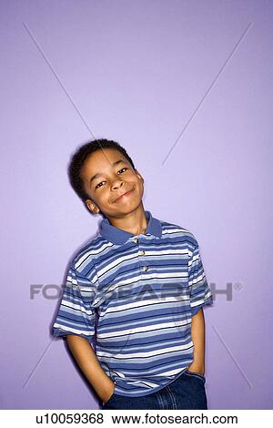 Stock Photo - Portrait of young boy with hands in pockets.. Fotosearch
