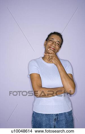 Picture - African American mature adult female standing looking at viewer. . Fotosearch