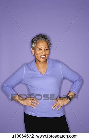 Stock Image - African American mature adult female standing smiling.. Fotosearch