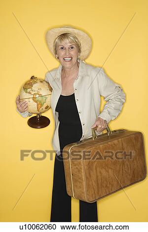 Caucasian mature adult female holding suitcase and globe. View Large Photo Image Stock Image - Caucasian mature adult female holding suitcase and globe.. Fotosearch