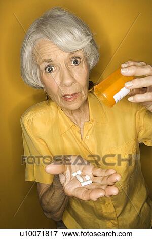 Stock Photo - Caucasian mature adult female with medication.. Fotosearch