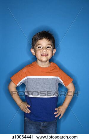 Male Hispanic boy standing with hands on hips. View Large Photo Image Stock Image - Male Hispanic boy standing with hands on hips.. Fotosearch