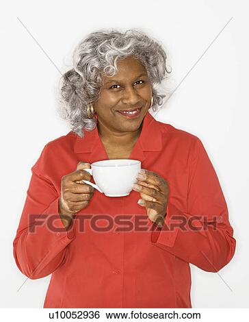 Mature adult African American female holding coffee cup smiling. View Large Photo Image Stock Photograph - Mature adult African American female holding coffee cup smiling.. Fotosearch