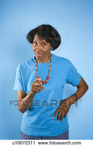 Prime adult female African American pointing with hand on hip. View Large Photo Image Stock Image - Prime adult female African American pointing with hand on hip.. Fotosearch