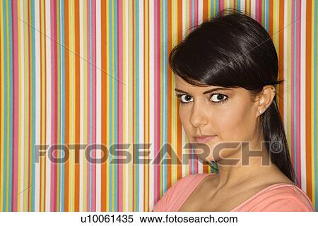 Young adult female Caucasian looking at viewer on striped background. View Large Photo Image Stock Photography - Young adult female Caucasian looking at viewer on striped background.. Fotosearch