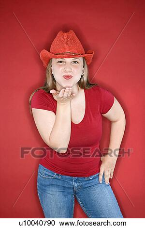Young Caucasian female adult blowing kiss wearing red cowboy hat. View Large Photo Image Stock Image - Young Caucasian female adult blowing kiss wearing red cowboy hat.. Fotosearch