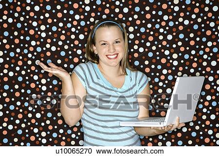 Young Caucasian woman holding laptop shrugging and smiling. View Large Photo Image Stock Image - Young Caucasian woman holding laptop shrugging and smiling.. Fotosearch