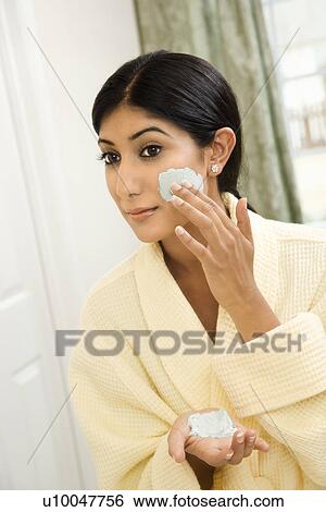 Close up of young Asian/Indian woman applying facial scrub. View Large Photo Image Stock Photograph - Close up of young Asian/Indian woman applying facial scrub.. Fotosearch